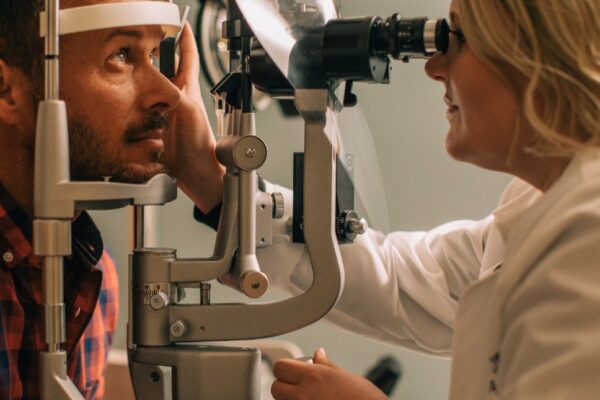 eye doctor examines patient through machine